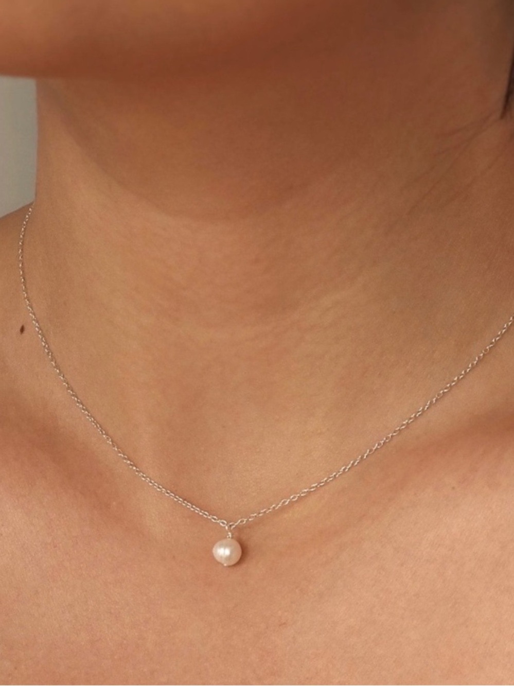 Silver pearl choker style necklace.